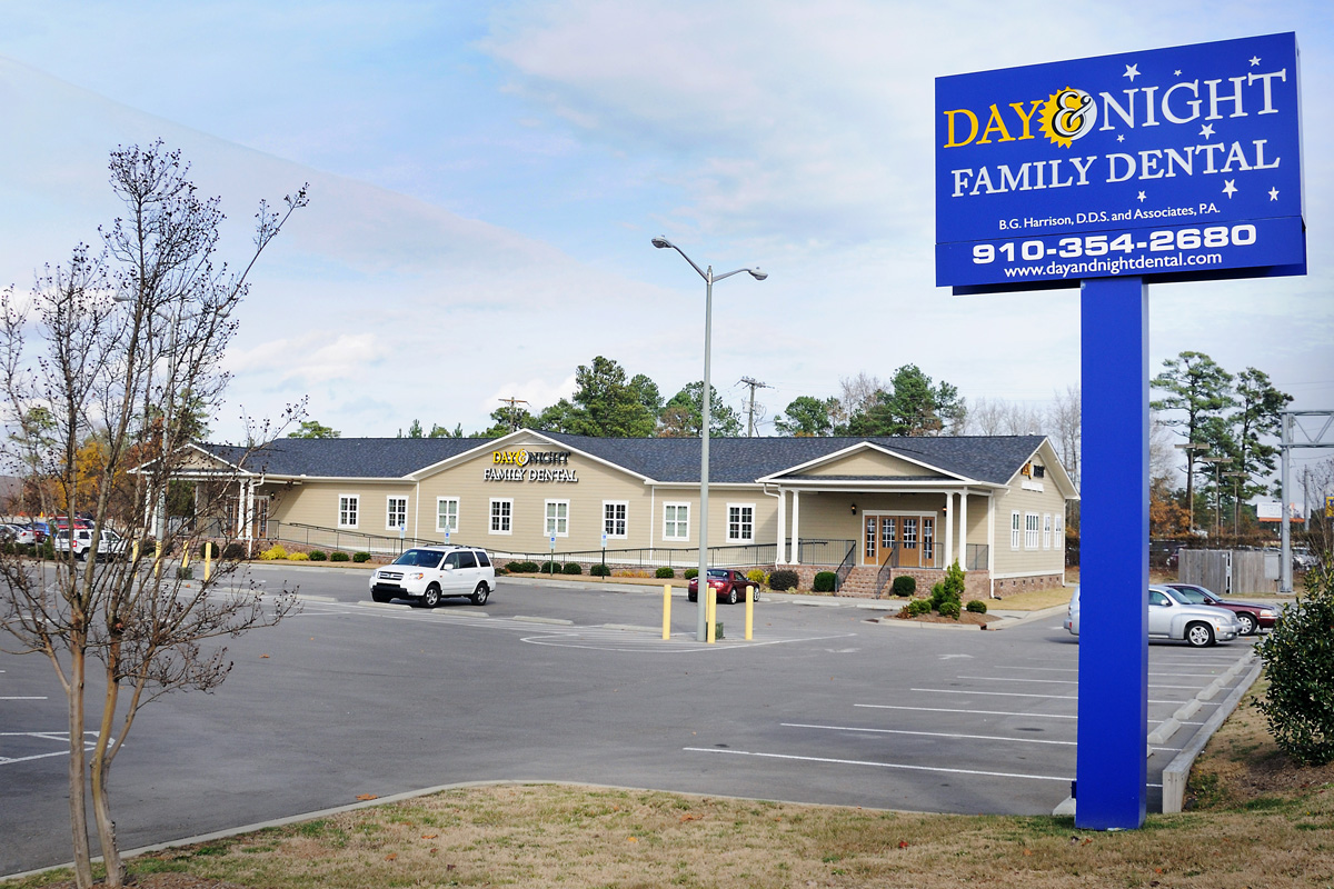 Photo of the exterior of the Day & Night Family Dental office, including the sign and parking lot